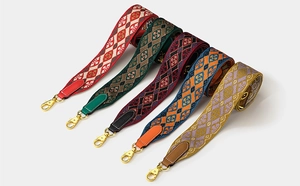 Detail of colorful jacquard wide shoulder straps with leather ends and gold metal buckles