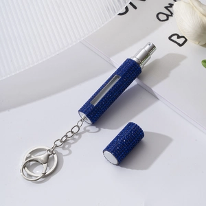 Macro view of blue rhinestone refillable perfume bottle with keychain and view window
