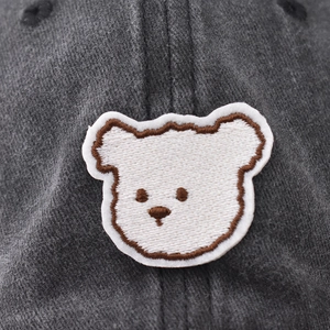 Vintage washed cotton baseball cap featuring detailed cute bear embroidery on dark grey fabric