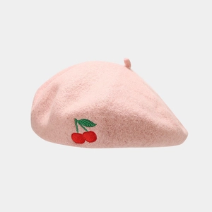 Detailed close-up of pink wool beret featuring delicate red cherry embroidery