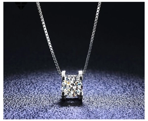 Macro shot of 925 silver necklace with sparkling round zircon in a four-prong setting