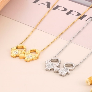 Detailed view of silver and gold cartoon boy and girl pendants with sparkling rhinestones