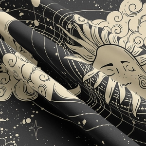 Detail of bohemian sun and star print on soft black fabric with fine woven texture