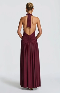 Elegant wine red halter neck maxi dress featuring a V-shaped backless design and pleated skirt