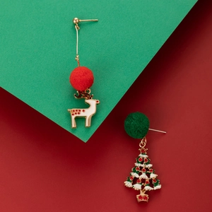 Detail of festive asymmetric Christmas earrings with elk and tree charms on red green base