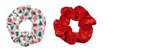 Close-up of Christmas satin scrunchies with festive tree and snowflake patterns on white background
