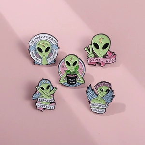 Set of five alien enamel pins with Stay Rad and Believe Yourself slogan designs