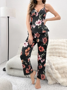 Detail of floral print satin pajamas set featuring elegant V-neck camisole and matching pants