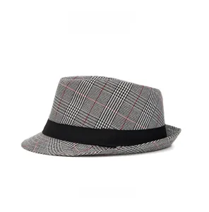 Detailed side view of a plaid fedora hat with a black ribbon band and classic check pattern