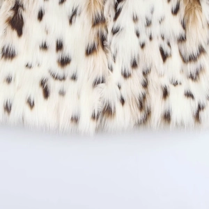 Close-up of premium leopard print faux fur jacket fabric showing soft texture and pattern