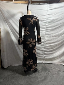 Rear view of long sleeve slim dress with beige floral print and ruffled cuffs detail
