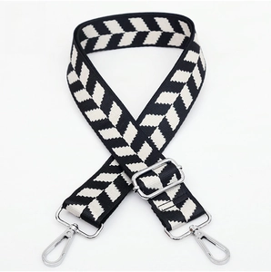 Adjustable jacquard bag strap featuring a black and white chevron pattern with silver hardware