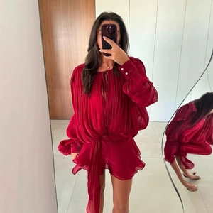 Red long sleeve romper with puff sleeves, ruffled hem, and pleated texture for women