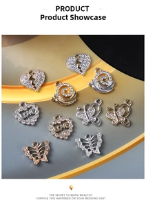Detailed view of alloy charms with rhinestones including heart, snail and butterfly designs