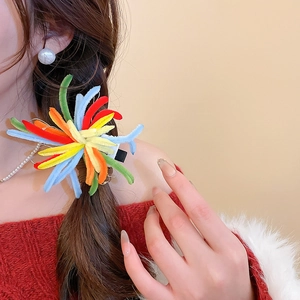 Detail of colorful velvet hair clip with multi-color splicing on a female model