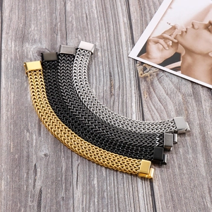 Detail of woven stainless steel bracelets in four colors on a rustic wooden background