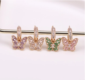 Detailed view of hollow butterfly charms with zircon inlays in four vibrant colors