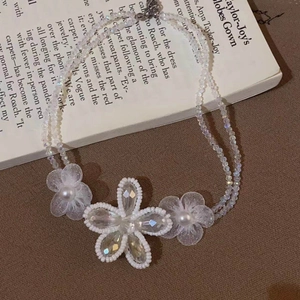 Detailed macro of crystal flower pendant with pearls on a double-strand beaded necklace