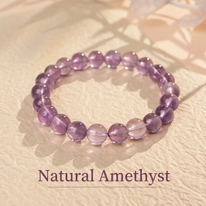 Macro detail of natural purple amethyst beaded bracelet on beige textured paper