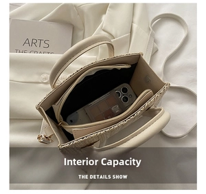 Interior view showing the storage capacity of the beige woven tote bag with zip compartment