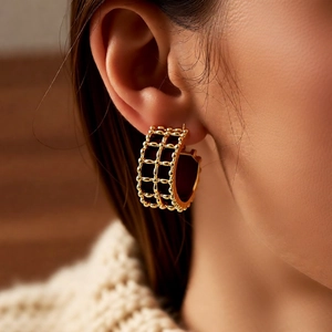 Detailed close-up of 18K gold plated hoop earrings with textured beaded mesh design