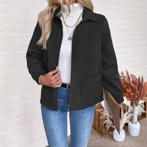 Detail of a women's black zip-up jacket featuring a turndown collar and large patch pockets