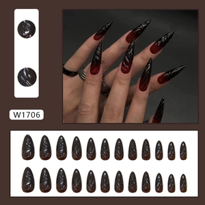 Black and red ombre stiletto press-on nails with 3D spiral texture and gradient finish