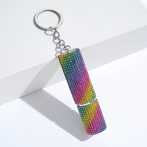 Detailed close-up of rainbow rhinestone perfume bottle keychain with silver metal ring