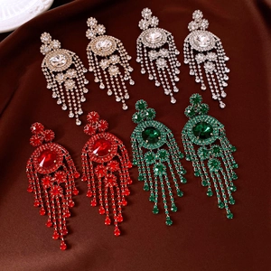 Macro shot of vintage rhinestone tassel earrings in gold, silver, red, and green colors