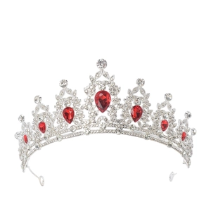 Detail of luxury silver crown with red teardrop crystals and sparkling rhinestones