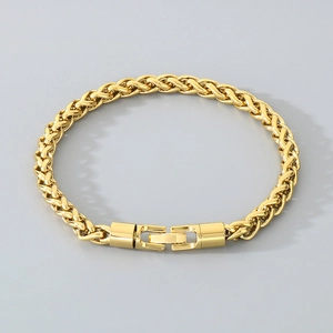 Detail of a golden wheat chain bracelet with a polished rectangular folding clasp