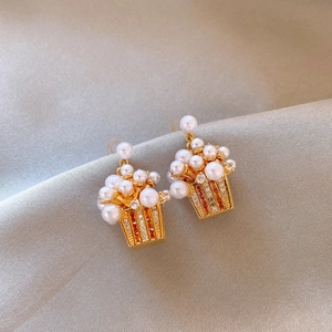 Macro view of 18K gold plated popcorn earrings featuring pearls and zircon inlays