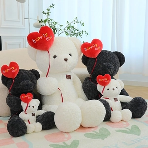 Group of plush teddy bears with red heart pillows embroidered with happily met text