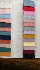 Detailed color swatches of textured muslin fabric with 26 shades for cotton baby bibs