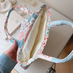 Detail of quilted floral cotton tote interior with patchwork and lining texture