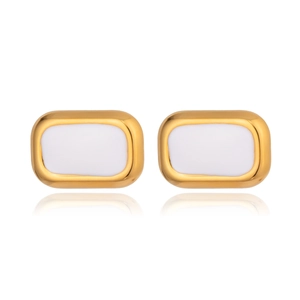 Detailed view of geometric rectangular gold earrings with white resin inlay finish