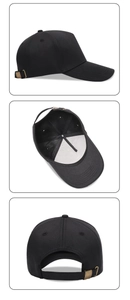 Detail view of black baseball cap with bronze metal buckle and six-panel canvas texture