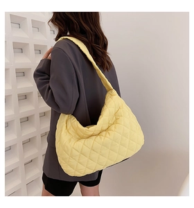 Yellow quilted space cotton tote bag worn by a model in a professional studio setting