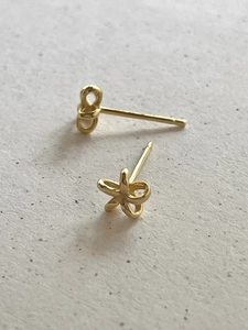 Close-up of elegant gold flower stud earrings with a polished metallic finish
