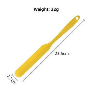 Detailed view of yellow silicone spatula with dimension markings 23.5cm and 2.2cm