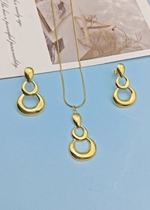 Close-up of triple-layered golden circle pendant necklace and matching earrings