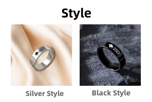 Detail of silver and black graduation rings 2024 with mortarboard cap and year engraving