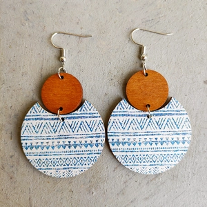 Detail view of bohemian wood earrings with tribal geometric print and brown circular studs