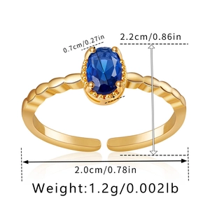 Detail of gold adjustable open ring featuring blue oval gemstone and wavy textured band