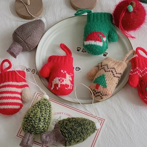 Detailed view of festive knitted Christmas ornaments featuring reindeer and snowflake patterns