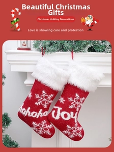Close-up of knit Christmas stockings with snowflake patterns and plush faux fur trim