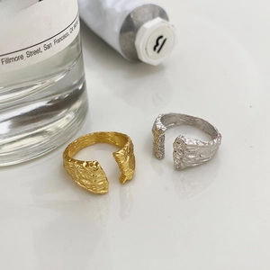Macro detail of S925 sterling silver rings with artistic bark texture in gold and silver