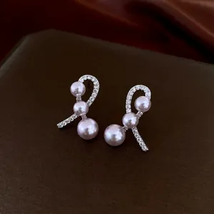 Elegant bow-shaped silver needle earrings featuring gradient purple pearls and zircon accents