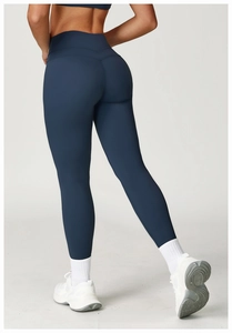 Detail view of high-waist yoga leggings in navy blue with scrunch butt lifting seams