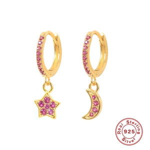 Macro detail of S925 sterling silver stamp on gold moon and star earrings with pink gems